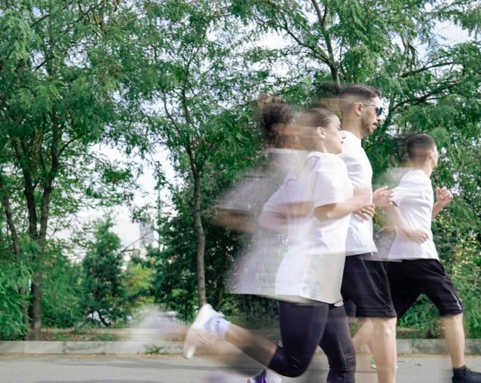 A group of people running down a street